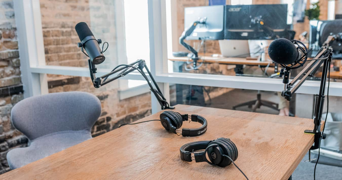 Headphones sitting on a table with microphone